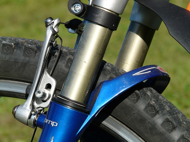 hands checking bicycle brakes and tires beginner maintenance awareness
